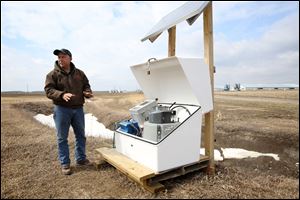 Terry McClure discusses the water runoff testing equipment situated on his land in Washington Township in Paulding County, Ohio. 