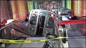 A Chicago Transit Authority train car rests on an escalator at the O'Hare Airport station after it derailed early Monday morning.