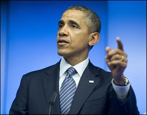 President Barack Obama speaks during a joint news conference with EU Council President Herman Van Rompuy and EU Commission President Jose Manuel Barroso at the EU-US summit meeting.