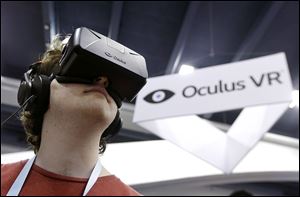Peter Mason tries the Oculus virtual reality headset at the Game Developers Conference 2014 in San Francisco. Facebook CEO Mark Zuckerberg believes Oculus can be a key tech platform of the future.