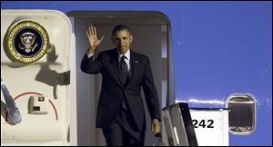 U.S. President Obama waves as arrives from Air Force One at Zaventem airport in Brussels on Tuesday.