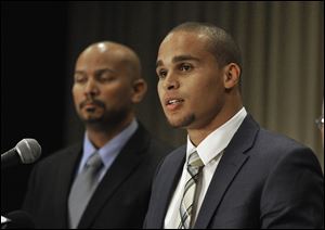 In this Jan. 28, 2014, file photo, Northwestern quarterback Kain Colter, right, speaks while College Athletes Players Association President Ramogi Huma listens during a news conference in Chicago. In a landmark ruling Wednesday, a federal agency has given football players at Northwestern University the green light to unionize.