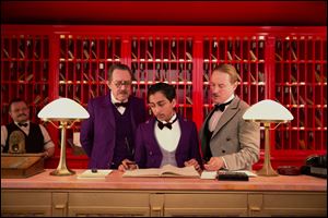 Tom Wilkinson, Tony Revolori, center, and Owen Wilson, right,  in 'The Grand Budapest Hotel.'