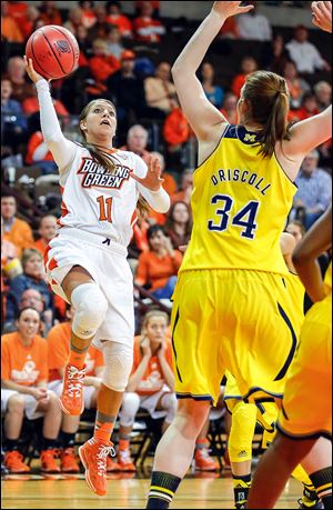 Bowling Green State University’s Jillian Halfhill shoots over Michigan’s Val Driscoll during the second half at Bowling Green. Halfhill scored 18 points before 2,403 fans at the Stroh Center. The Falcons will play Rutgers in Bowling Green on Monday.