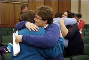 Kat White, left, and Sue Walton hug after being married in a group ceremony by the Oakland County Clerk in Pontiac, Mich., Saturday after a federal judge has struck down Michigan's ban on gay marriage. 