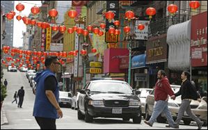 San Francisco police patrol the Chinatown district Thursday.