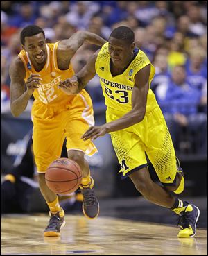 Michigan's Caris LeVert, right, runs past Tennessee's Jordan McRae during the second half on Friday.