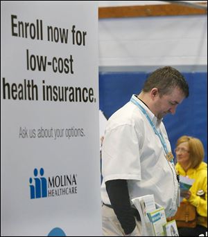 Jeffrey Adkins from Molina Healthcare waits in his booth to talk to people about the process of applying for the Affordable Care Act marketplace.