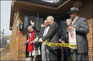 Mayor D. Michael Collins, left, and Councilman Tom Waniewski cut the tape to reopen the Toledo Police Department's Northwest District Substation.