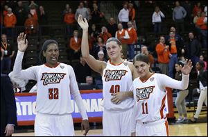 BGSU seniors, from left, Alexis Rogers, Jill Stein, and Jillian Halfhill wave good-bye to fans after their loss to Rutgers in the WNIT on Monday. The Falcons won 30 games this season, the second-highest total in Mid-American Conference history.