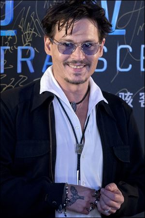 Actor Johnny Depp attends a promotional event for his new movie “Transcendence” in Beijing, China, today.  Depp showed off a diamond engagement ring that he called a “chick’s ring,”indirectly confirming rumors of his engagement to actress Amber Heard. 