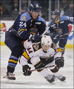 Toledo Walleye player Richard Nedomlel, shoving Cincinnati Cyclones’ Jonathan Hazen, says he plays hard to protect his teammates. Nedomlel says he was big for his age and thus played meaner and more aggressively back home in the Czech Republic.