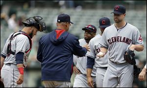 Cleveland Indians' Corey Kluber, right, hands the ball to manager Terry Francona as he exits the game against Oakland.