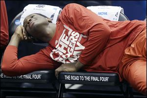 Wisconsin forward Nigel Hayes lays on the bench to relax before an NCAA tournament game. The Badgers play Kentucky on Saturday.