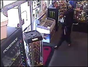 Surveillance video still from the robbery at Mickey's Smoke Shop.