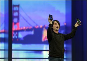 Microsoft Vice President Joe Belfiore holds up a phone using the new Windows 8.1 operating system during the keynote address of the Build Conference Wednesday in San Francisco. Microsoft kicked off its annual conference for software developers  with updates and new features for Windows Phone and Xbox.