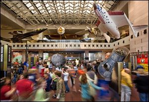 Visitors walk through the Milestones of Flight Gallery, the main hall of the Smithsonian’s National Air and Space Museum, in Washington. 
