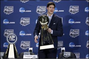 Creighton's Doug McDermott holds up his AP College Basketball Player of the Year trophy today at a news conference in Dallas.