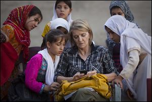 Associated Press Special Regional Correspondent for Afghanistan and Pakistan Kathy Gannon sits with girls at a school in Kandahar, Afghanistan in 2011. Gannon was wounded in the shooting in Afghanistan today.