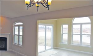 The sunroom offers a beautiful view of the pond.