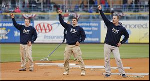The grounds crew dances during the fifth inning  of Friday’s season opener at Fifth Third Field.