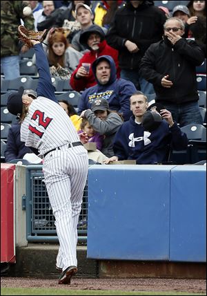 Mud Hens first baseman Jordan Lennerton  makes a catch against Louisville near the stands in the fifth inning.