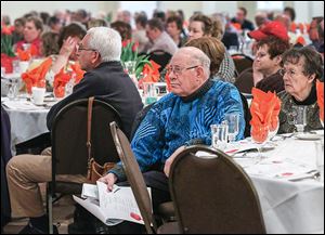 Tiffin residents Kenny Dininger, center, and Imelda Dininger, right, attend the 17th annual Parkinson’s Disease Symposium at the Parkway Place in Maumee.