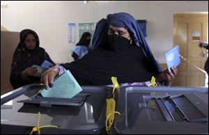 An Afghan woman casts her vote at a polling station in Jalalabad last Saturday. 