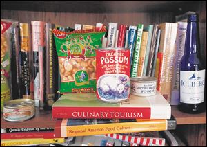 Food items that Lucy Long displays in her home sit atop two of her published books.