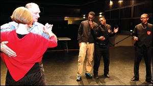 Instructors Jennifer Jarrett and Dave Morris demonstrate the waltz to Woodward High School students Daijour Whittington, left, Isaiah Jefferson, and Dayshawn Jones.