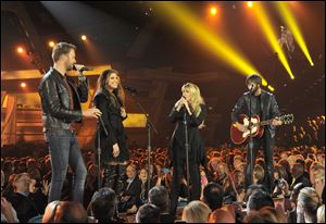Stevie Nicks, second from right, and from left, Charles Kelley, Hillary Scott and Dave Haywood, of the musical group Lady Antebellum, perform at the MGM Grand Garden Arena in Las Vegas.