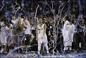 Connecticut guard Shabazz Napier (13) celebrates after winning the NCAA Final Four tournament college basketball championship.
