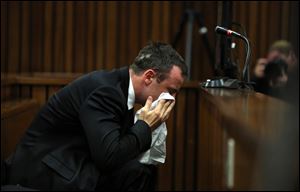 Oscar Pistorius weeps as he listens to evidence by a pathologist in court in Pretoria, South Africa, today. Pistorius is charged with murder  for the shooting death of his girlfriend Reeva Steenkamp, on Valentines Day 2013. 