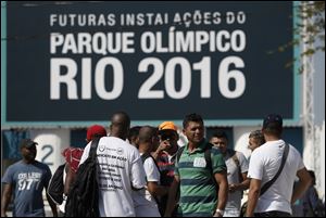 Striking workers stand in front the entrance of the Olympic Park, the main cluster of venues under construction for the 2016 Summer Olympic Games, in Rio de Janeiro, Brazil today.
