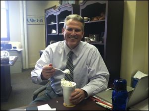 Perrysburg School Superintendent Tom Hosler with his Mr. Freeze prize because he won the March Madness competition.