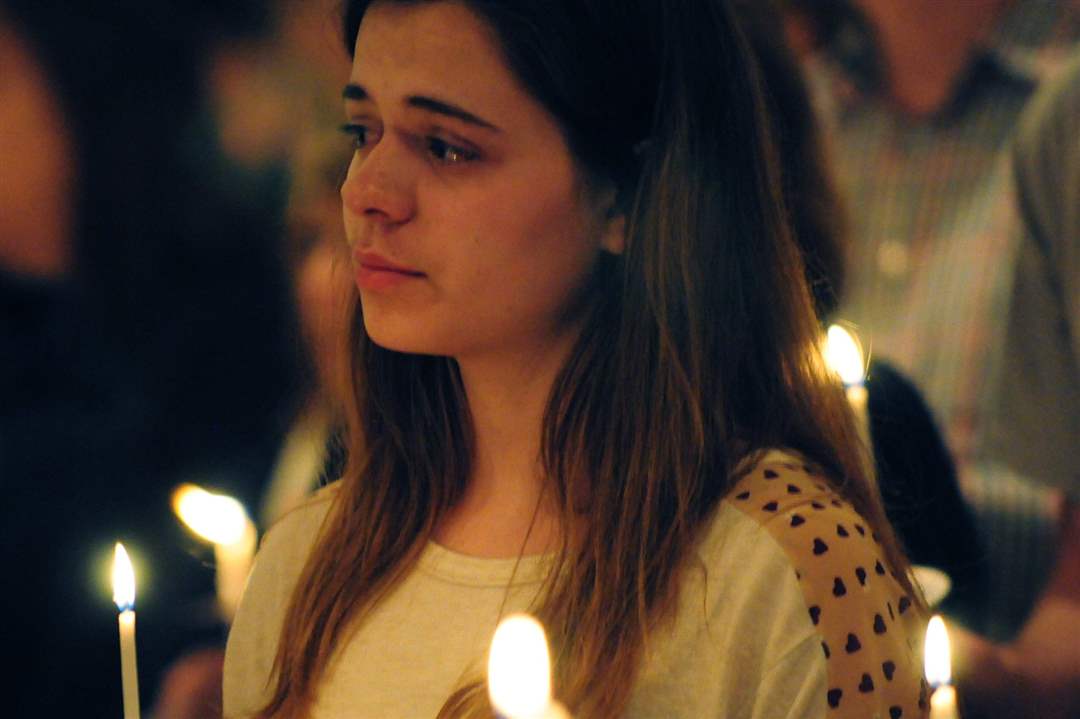 A-girl-tears-up-during-a-prayer-and-vigil-service