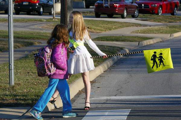 Crossing-guard-Lizzy-Lucal-right-helps-the-lead-student-fro