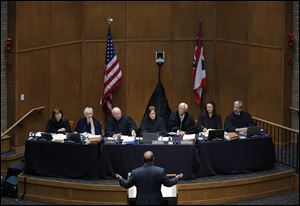 Ohio Supreme Court justices, from left: Justice Judith L. French, Justice Judith Ann Lanzinger, Justice Paul E. Pfeifer, Chief Justice Maureen O'Connor, Justice Terrence O'Donnell, Justice Sharon L. Kennedy, and Justice William M. O'Neill listen as Douglas Cole, an attorney for Cedar Fair LP, argues during a session of the Supreme Court of Ohio in the McQuade Law Auditorium at The University of Toledo College of Law.