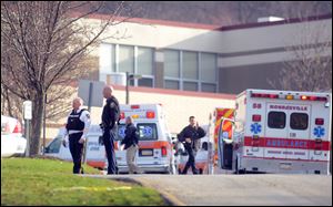 Officials outside of Franklin Regional High School in Murrysville, where multiple people were stabbed early today.