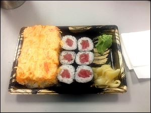 The spicy girl, filled with tempura salmon and topped with spicy crab, is paired with a basic tuna roll.