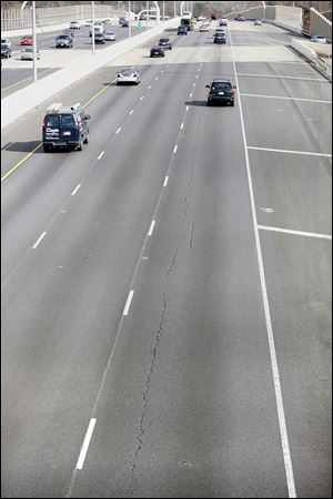 Cracks in the new pavement of eastbound I-475 in West Toledo could have been caused by a design flaw, a problem with the materials that were used, or faulty workmanship, a deputy director of the state transportation district said.
