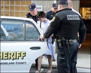 Authorities take attack suspect Alex Hribal, 16, from the magistrate’s office after his arraignment in the stabbing of students at Franklin Regional Senior High School in western Pennsylvania.