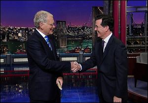 David Letterman shaking hands with fellow talk show host Stephen Colbert of ‘The Colbert Report,’ during a surprise visit on the ‘Late Show with David Letterman,’ in 2011 in New York.
