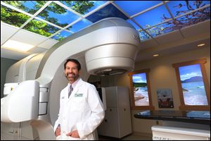 Dr. Robert Lavey, director of the Cancer Care Center at Wood County Hospital, stands near the facility’s linear accelerator. Construction began on the $5 million, 7,000-square-foot facility in fall, 2013. The first patients to receive radiation therapy will begin treatment on Monday. 