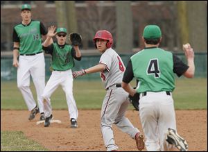 Adam Buenrostro of Cardinal Stritch gets caught in a rundown in the seventh inning between Ottawa Hills’ Dominic Adduci, left, and Parker Riepenhoff. The Cardinals are 3-0 this season.