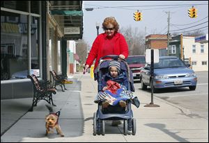 Anita Friend takes a stroll with her grandson Benton Rogge, 2, and her dog Lucy in downtown Antwerp. 
