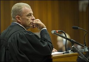 State prosecutor, Gerrie Nel, questions Oscar Pistorius in court in Pretoria, South Africa,  today.