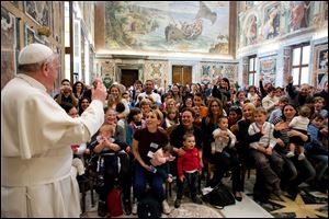 Pope Francis delivers his blessing during a meeting with the Italian pro-life movement, at the Vatican today.