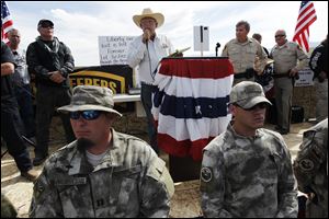 Rancher Cliven Bundy, middle, addresses his supporters along side Clark County Sheriff Doug Gillespie, right, on April 12, 2014. Bundy informed the public that the BLM has agreed to cease the roundup of his family's cattle.