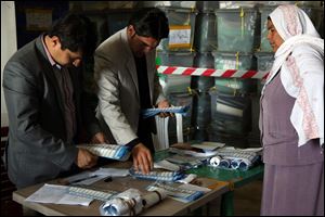 Afghan election workers counts ballots at a Independent Election Commission office Sunday in Kabul, Afghanistan.